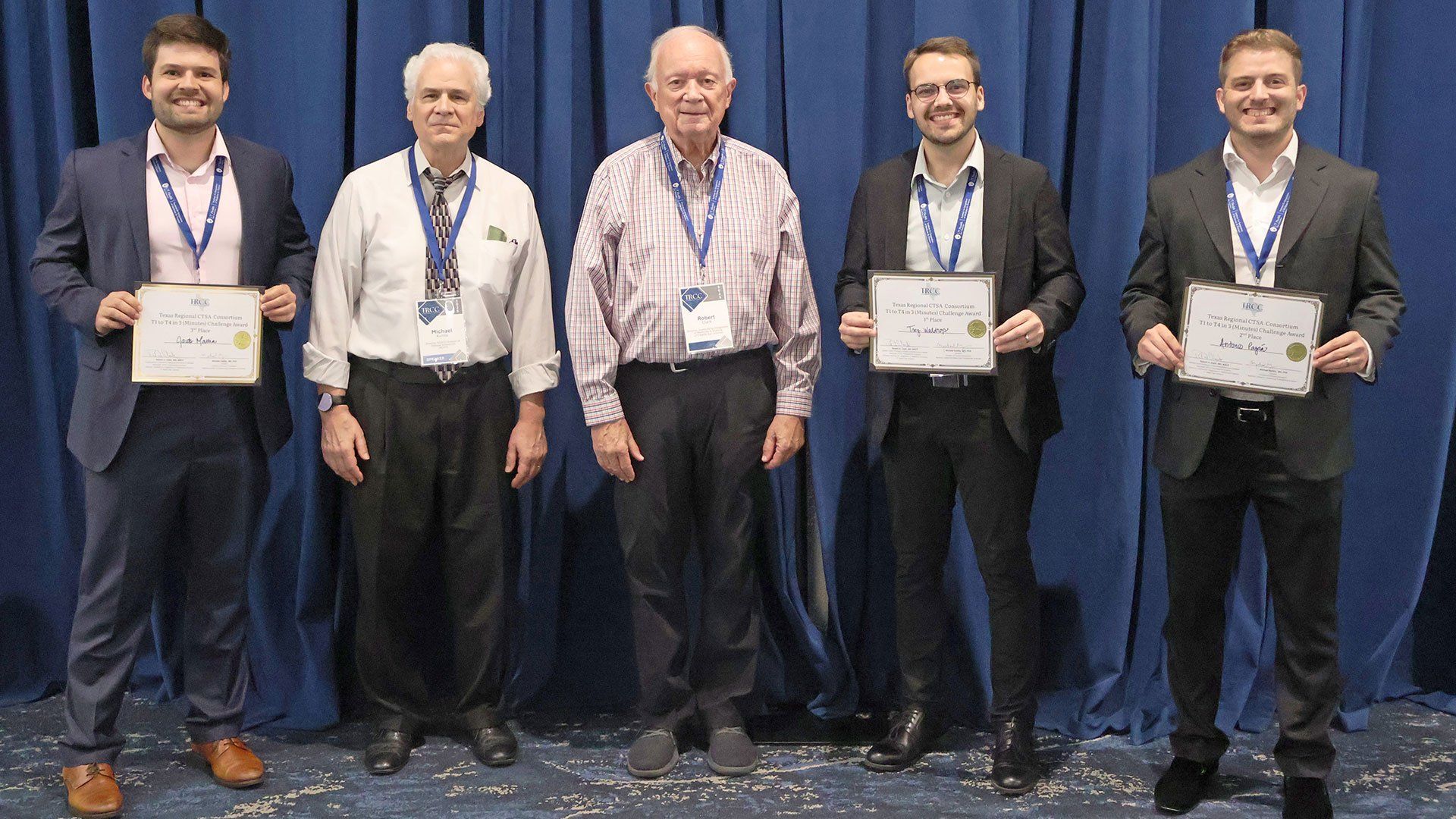 Group photo of the winners. From left to right: Second place winner Jacob Mattia, judge Michael Kurilla, MD, PhD, judge Robert Clark, MD, first place winner Trey Waldrop, and third place winner Antonio Pagán.