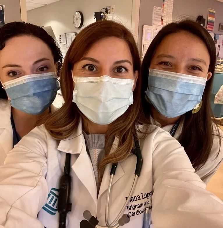 Diana Lopez with two colleagues wearing surgical masks.