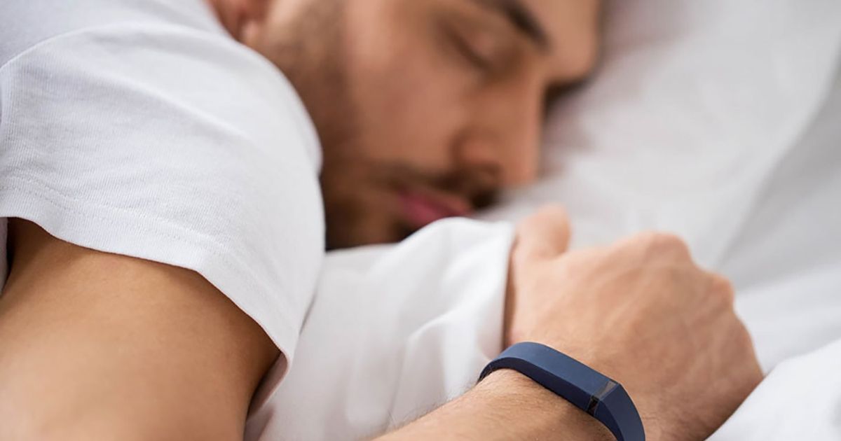 stock photo of person sleeping and wearing activity tracker
