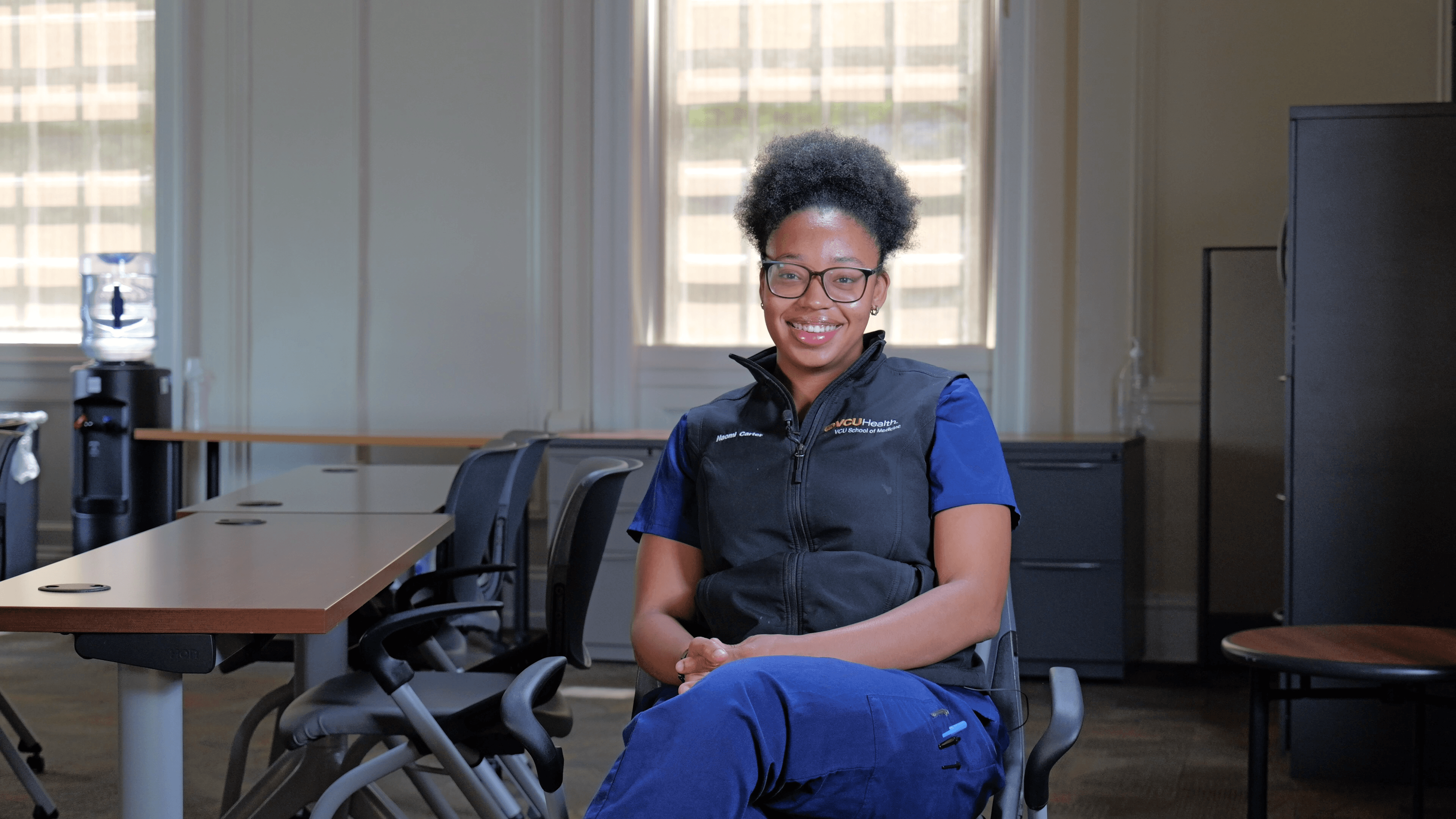 Photo of Naomi Carter sitting in a black office chair